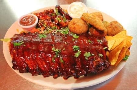 pork baby back ribs platter with bbq sauce