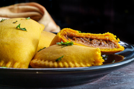 Spicy Jamaican beef turnovers with mint garnish